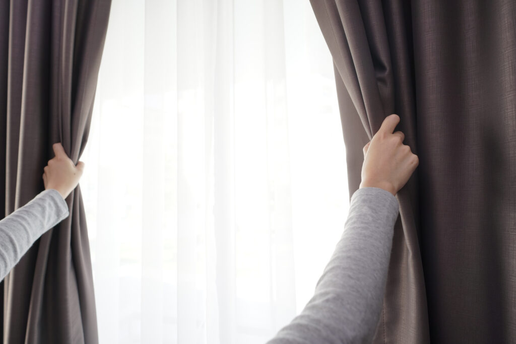 closeup-women-hand-opening-curtain